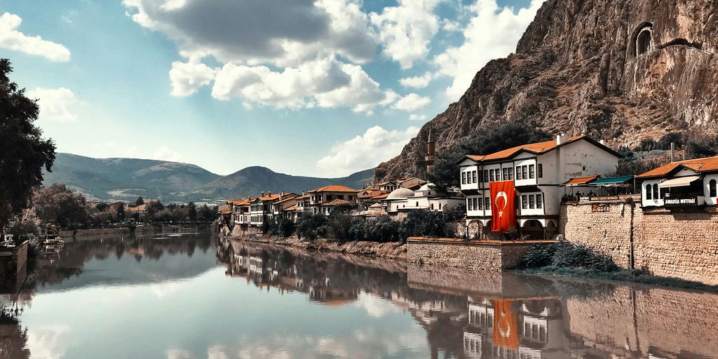 buildings beside calm body of water